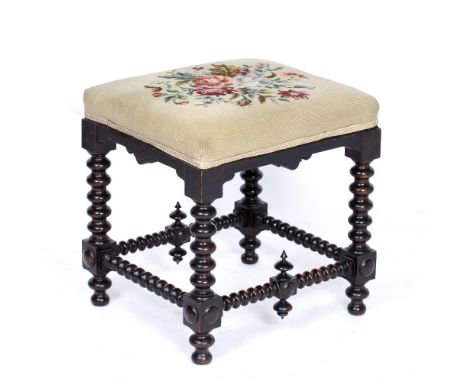 A 19TH CENTURY STOOL  with needlepoint upholstered seat and bobbin turned supports, 46cm wide x 40cm deep x 46cm high