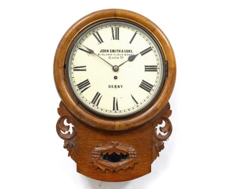 A LATE VICTORIAN OAK DROP DIAL WALL CLOCK with carved foliate decoration, the dial painted with Roman numerals and signed 'Jo