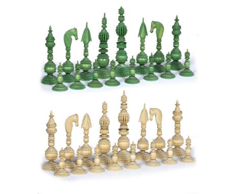 AN INDIAN 'PEPYS' PATTERN IVORY CHESS SET one half stained green, the Kings 14.5cm high (some minor losses)