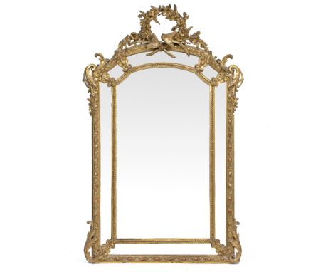 A 19TH CENTURY FRENCH PIER GLASS OR WALL MIRROR with gilt gesso moulded frame, the arching top surmounted by a floral wreath 