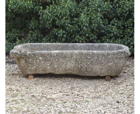 AN ANTIQUE MARBLE TROUGH  with rounded ends, 144cm long x 60cm deep x 32cm high