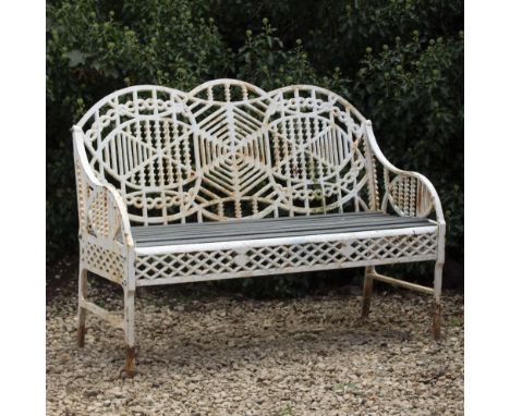 A WHITE PAINTED CAST  IRON GARDEN BENCH with pierced decoration and a wooden slatted seat, 122cm wide x 48cm deep x 92cm high