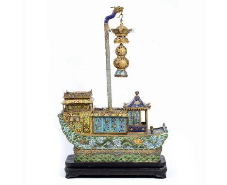 A CHINESE GILT METAL AND CLOISONNE ENAMEL ORNAMENT in the form of a barge with galleried superstructure, decorated with folia