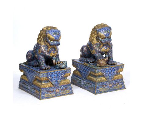 A PAIR OF CHINESE ENAMEL AND BRASS TEMPLE DOGS each on rectangular plinth bases, 43cm wide x 59cm deep x 78cm high (2)