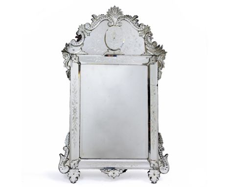 A VENETIAN WALL MIRROR with engraved floral decoration and panelled sides, 77cm wide x 128cm high