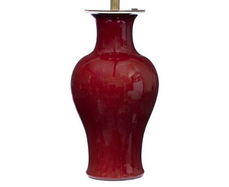 A TABLE LAMP  converted from a Chinese oxblood red baluster vase, with flaring rim, 17cm diameter x 42cm high to the light fi