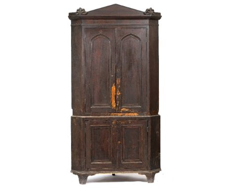 A REGENCY SCUMBLED PINE CORNER CABINET with palm etched decorated crest, gothic arched decorated panel doors above and panel 