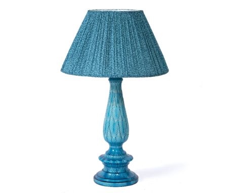 A TURQUOISE GLAZED POTTERY TABLE LAMP the central column with leaf moulded decoration and with a turquoise leaf patterned fri