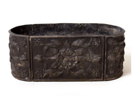 A LEAD PLANTER WITH ROUNDED ENDS AND DECORATED WITH FLOWERHEADS 54cm wide x 24cm deep x 21cm high