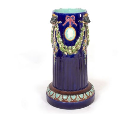 A VICTORIAN MAJOLICA POLYCHROME DECORATED STICK STAND in the form of a classical column with lion mask fruiting swags, 39cm d