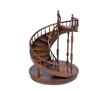A STAINED WOODEN MODEL OF A SPIRAL STAIRCASE 46cm diameter x 60cm high 