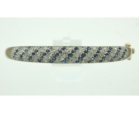 9ct gold diamond and sapphire bangle, D: 62 mm, 10.3g. UK P&amp;P Group 1 (£16+VAT for the first lot and £2+VAT for subsequen