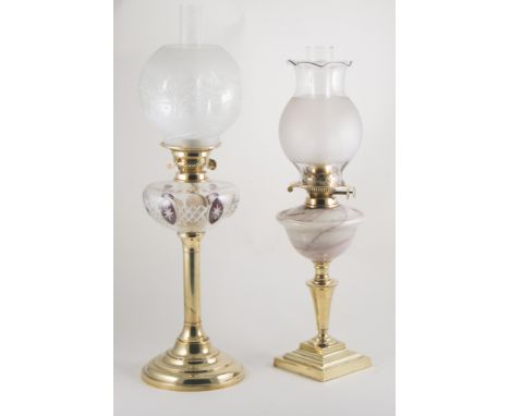 Two brass oil lamps (one with damaged globe), and brass watering can, (3).