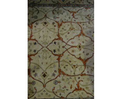 A Pakistan Mughal carpet, allover Ziegler design in tones of burnt orange and tan against a sand ground, enclosed by similar 