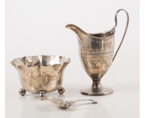 Late Georgian silver helmet shaped-cream jug, bright-cut, engraved initials, 13cm; an Edwardian silver sugar bowl, and a silv