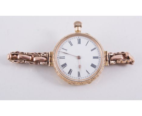 An open face fob watch with white enamel dial and arabic numeral chapter ring, 14K floral and scroll engraved outer case, met
