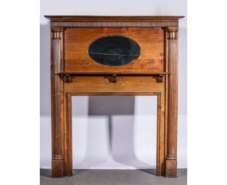 Mahogany fire surround, inset with oval mirror above a mantel shelf, flanked by fluted columns, width 166cm, depth 25cm, heig