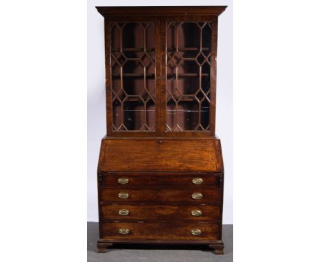 A George III mahogany bureau, fall front enclosing a well fitted interior with amboyna and rosewood faced drawer with arcaded