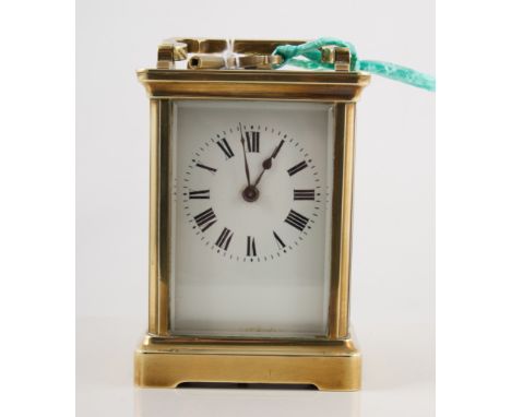 French time piece carriage clock, white enamel dial with roman numeral chapter ring, polished brass case with oval glass to t