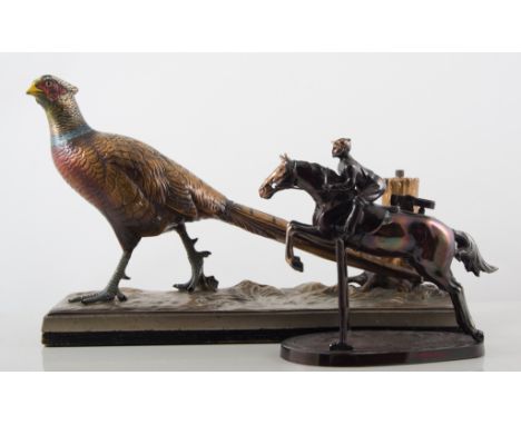 A foreign silver plated novelty table lighter, designed as a horse and rider jumping a fence, 15cms, and a cold painted table