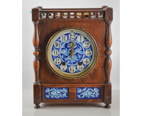 An Aesthetic Movement oak cased mantel clock, blue floral painted dial and rectangular insets, in the manner of Lewis Foreman