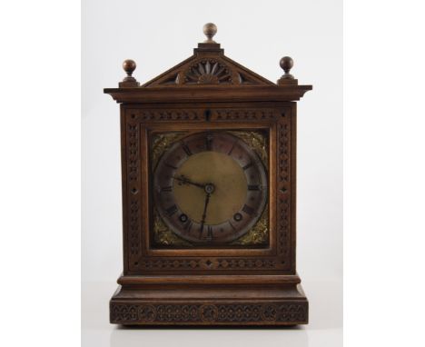 A Continental beech cased mantel clock, architectural form, brass dial, the movement stamped W & H, striking on a gong, 31cms