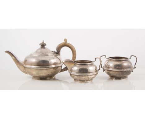 Three-piece silver tea set, small bulbous form with ribbed waistband, hallmarked London 1922, small pair of sugar tongs, tota