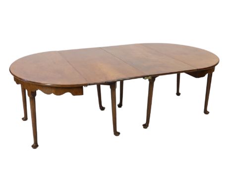 A George II mahogany extending dining table, with two single drop leaf D ends and serpentine aprons, on tapered legs with pad