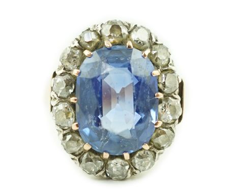 A Victorian gold, sapphire and diamond set oval cluster ring, the sapphire measuring approximately 12.5mm by 10.5mm, with a d