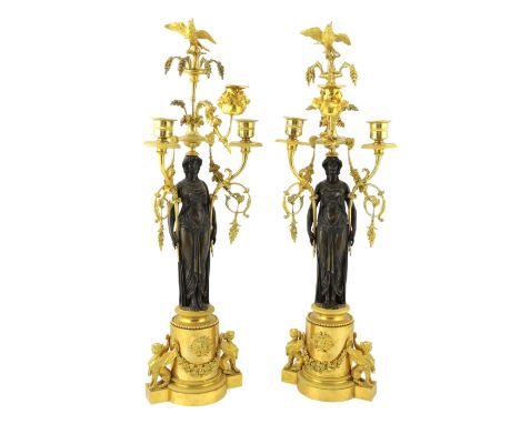 * A pair of late 19th century French Empire style bronze and ormolu three light candelabra, with bird finials, foliate scroll