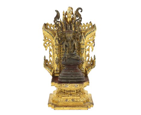 A Burmese gilt bronze seated figure of Jambupati Buddha on a throne, Shan, 17th-18th century, in bhumisparsa mudra, wearing t