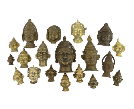 A group of eighteen bronze or brass Shiva masks, Southern India, 16th-19th century, 6.2 - 19.5cm highProvenance: bought from 