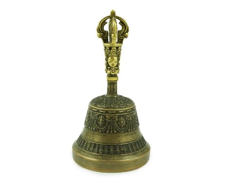 A Tibetan bronze ghanta bell, 18th/19th century, the handle cast with a bodhisattva head, the bell with Sanskrit inscription 