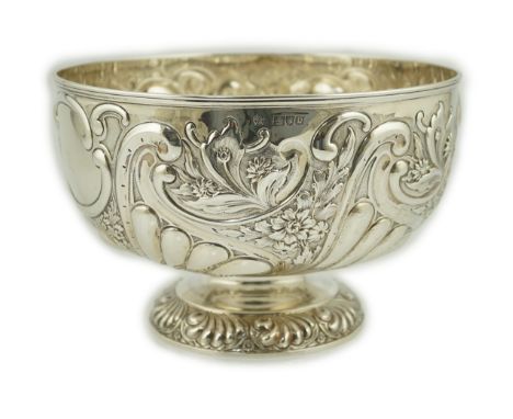 A late Victorian repousse silver rose bowl, by William Hutton &amp; Sons, decorated with foliage and scrolls, on pedestal foo