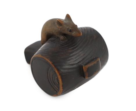 * A Japanese carved wood rat netsuke, early 19th century, formed as a rat, with inlaid eyes, resting on Daikoku’s mallet, 4cm