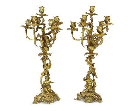 A pair of late 19th century French Louis XVI style ormolu seven light candelabra, each with foliate scroll and flower stems, 
