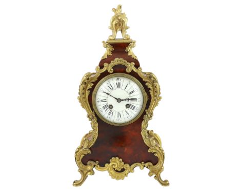 An early 20th century French ormolu mounted red tortoiseshell eight day mantel clock, of Louis XVI style, with enamelled dial