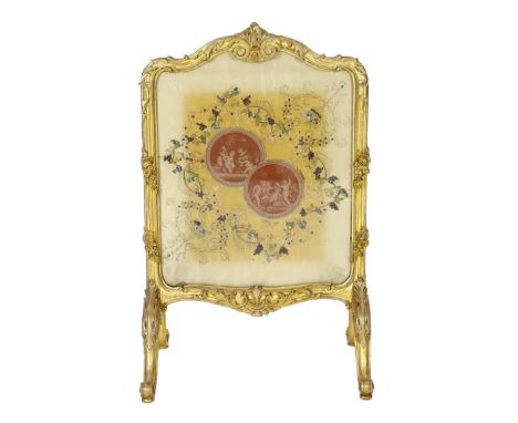 * A Louis XV style carved giltwood framed fire screen, the silk panel printed with roundels of playful amorini, within natura