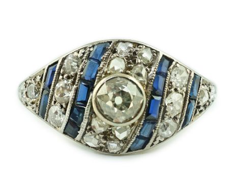 A 1940's/1950's 18ct white gold, sapphire and diamond set cluster ring, the central diamond surrounded with millegrain set ro