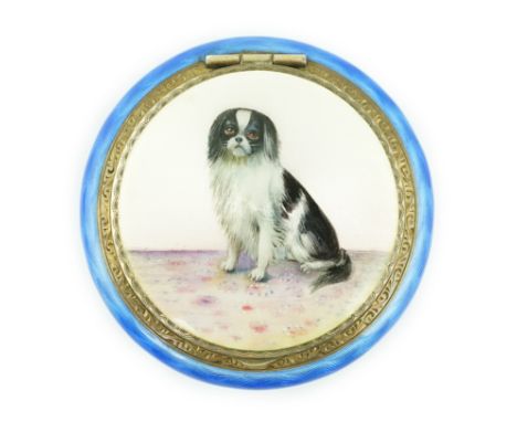 A George V silver gilt and enamel circular compact, decorated with a seated dog, import marks for P.H. Vogel, London, 1926, 5