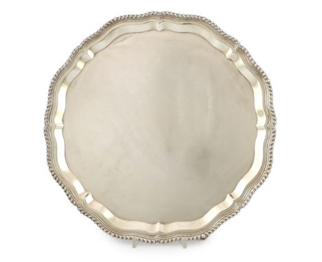 A large Elizabeth II circular silver salver, with piecrust and gadrooned edge, on four scrolled feet, by J.B. Chatterley &amp