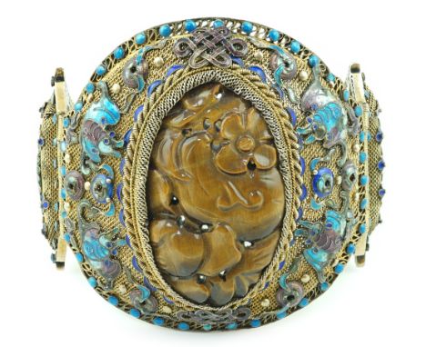 A Chinese silver-gilt, enamel and tiger's-eye bracelet, early 20th century, head 68mm by 65mm, gross weight 91 grams.***CONDI