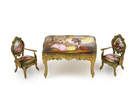 A 20th century Swiss enamel and ormolu musical miniature doll's house table with a pair of matching salon chairs, each decora