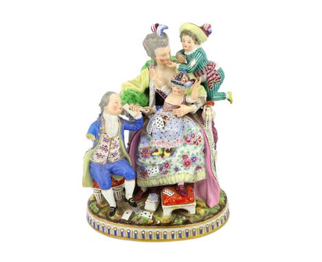 A Meissen group The Good Mother, 19th century, with good detail to the clothing, playing cards and base, blue crossed swords 