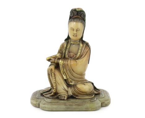 A Chinese soapstone seated figure of Guanyin, 17th/18th century, holding a scroll in the left hand and a rosary of beads in h