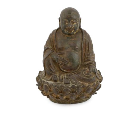 A Chinese lacquered bronze figure of Budai, late Ming dynasty, the figure seated on a lotus throne, 23cm high, cracks and old