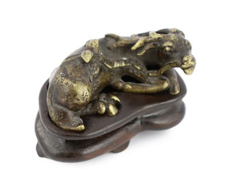 * A Chinese bronze weight, in the form of a recumbent deer, late Ming/early Qing dynasty, 5.2cm long, wood standPlease note t