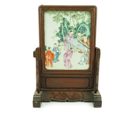 A Chinese famille rose porcelain mounted hongmu framed table screen, 19th century, the porcelain plaque painted with scholars