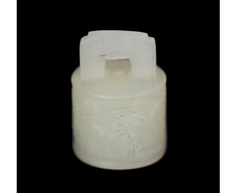 * A Chinese miniature white jade seal of archaic bronze bell form, late Qing dynasty, carved in low relief with scrolling clo