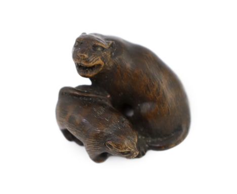 * A Japanese carved wood netsuke of a tiger and cub, 19th century, unsigned, 2.2cmProvenance: J. Hubbard Ltd, 24th July, 1987